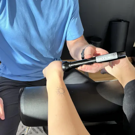 Patient receiving laser therapy on their foot.