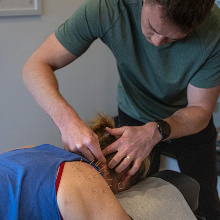 Patient with needles in their shoulder.