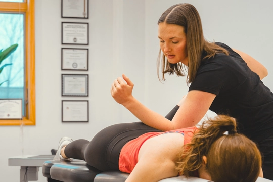 Hannah Spaulding giving a back adjustment.