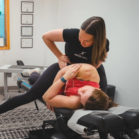 Chiropractor adjusting a patients back.
